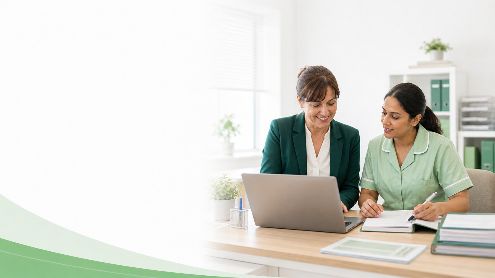 Care home manager and staff member reviewing information together